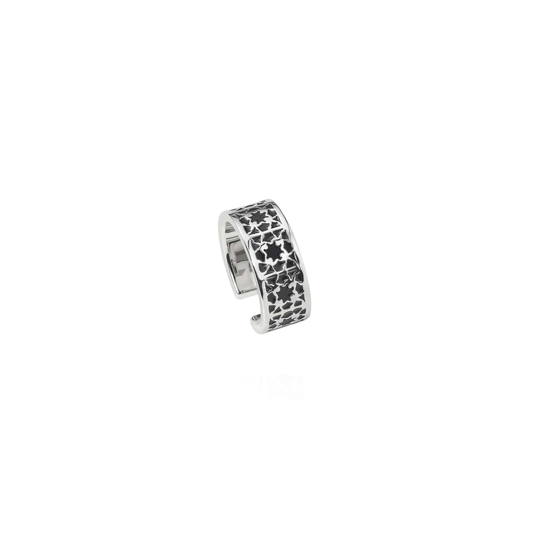 Risis Peranakan Orchid Ring with Black Enamel - This is a silver-colored ring featuring a pattern of black stars and florals against its reflective metal surface, designed with an open band style.