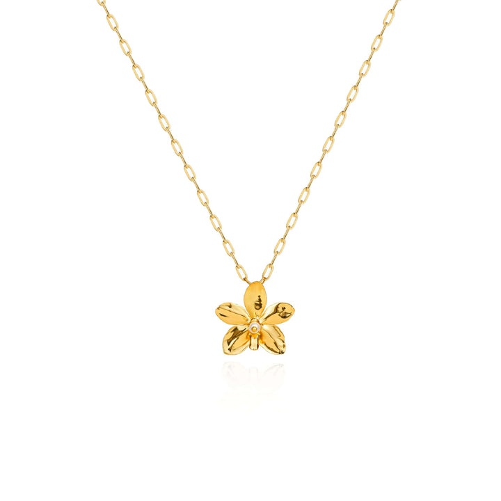 Risis Aeridovanda Blooms Necklace - A golden necklace with a delicate, shiny orchid pendant, featuring a central pearl accent, dangles gracefully. The orchid has five polished petals.