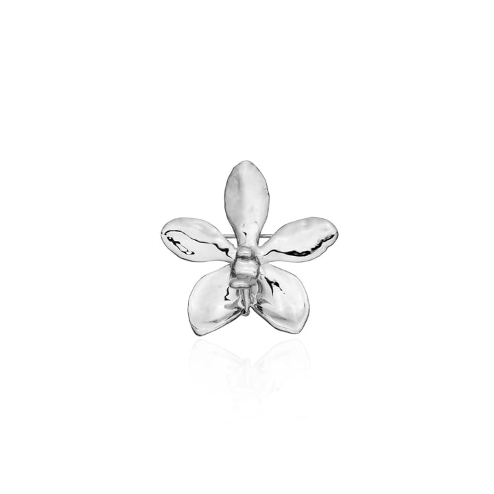Risis Aeridovanda Vieng Ping Orchid Brooch/Pendant - A shiny silver flower-shaped object with smooth, reflective petals stands centered against a pure background, exuding simplicity and elegance.