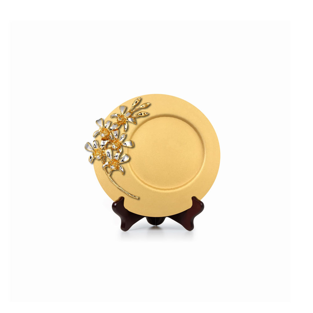 Risis Dendrobium Li Min Eng Orchid Spray On 8 Inch Plaque - A circular golden plate with a delicate, floral jewelry piece on its edge, featuring sparkling gemstones and gold accents, displayed on a small stand.