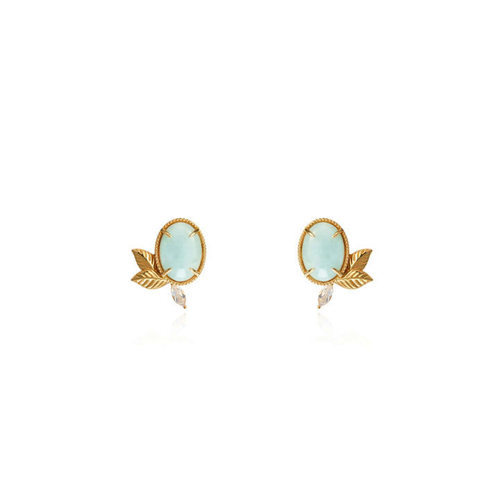 Risis Jadeite Prairie Earrings - A pair of gold-tone earrings, each with a pale blue oval gemstone set in a beaded bezel, flanked by a small leaf motif and clear teardrop crystal below.