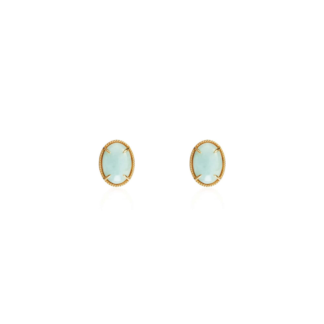 Risis Jadeite Prairie Earrings - A pair of oval-shaped earrings featuring pale blue stones set in gold bezels, conveying delicate elegance.