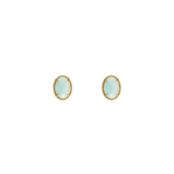 Risis Jadeite Prairie Earrings - A pair of oval-shaped earrings featuring pale blue stones set in gold bezels, conveying delicate elegance.