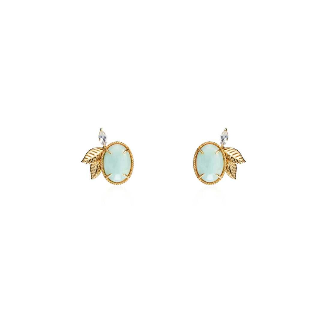 Risis Jadeite Prairie Earrings - A pair of earrings with round pale blue stones set in gold, accented with a textured gold leaf and a small clear gemstone at the top.