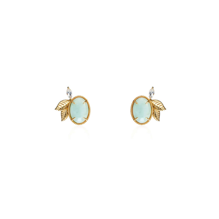 Risis Jadeite Prairie Earrings - A pair of earrings with round pale blue stones set in gold, accented with a textured gold leaf and a small clear gemstone at the top.