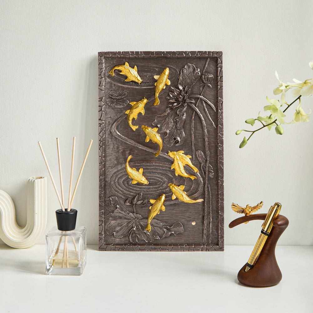Risis Nine Carp Lotus Frame - A rectangular dark brown panel features a relief of golden koi fish swimming among carved floral elements, creating a striking contrast and dynamic artwork.