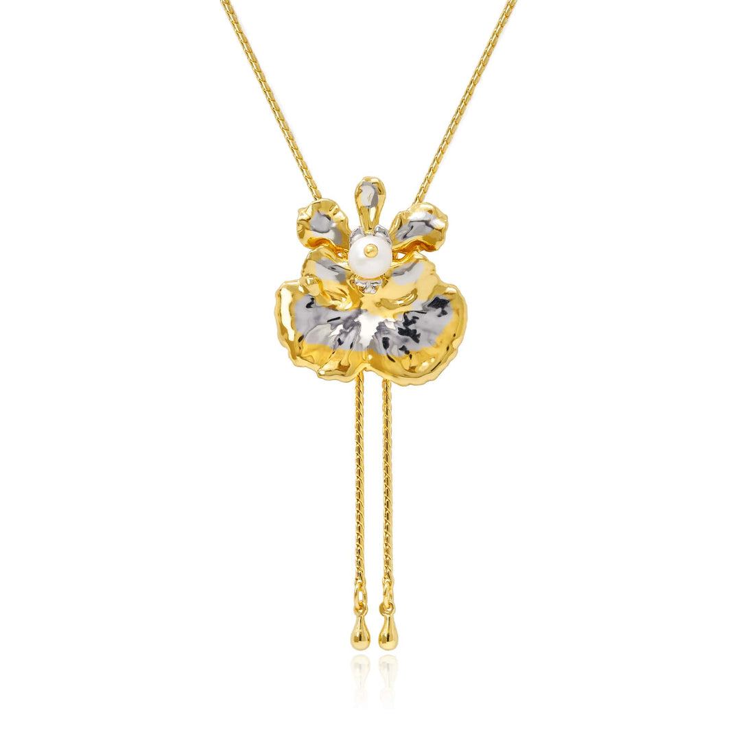 Risis Oncidium Coco Drop Pearl Slider Necklace (PG) - A golden-yellow flower pendant with silver-white accents, adorned by a central pearl, hangs from a chain, featuring delicate gold tassels beneath.