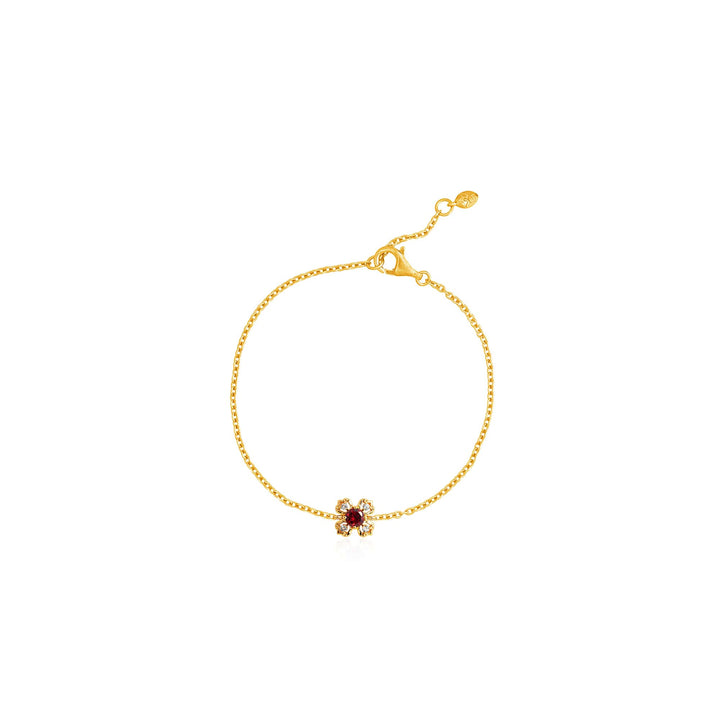 Risis Petite Peranakan Kebaya Bracelet With Garnet - A delicate gold bracelet with a thin chain and a small red gemstone flanked by tiny clear crystals at its center.