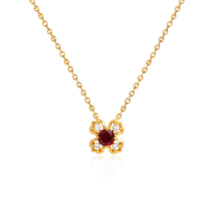 Risis Petite Peranakan Kebaya Necklace With Garnet - A gold necklace with a pendant featuring a central red gem surrounded by delicate gold petals, each petal accented with a small clear gemstone.