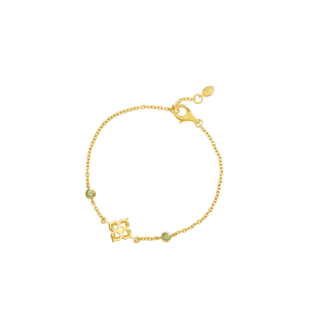 Risis Timeless Peranakan Bracelet With Peridot - A golden bracelet with a delicate chain, featuring a central geometric motif and two small green gemstones, set in a simple yet elegant design.