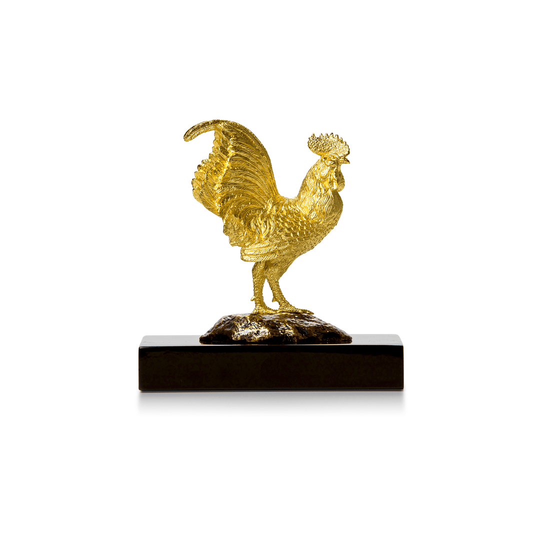 Risis Wisdom Rooster - A golden rooster sculpture with intricate feather textures stands atop a dark, textured base, exuding elegance and craftsmanship.