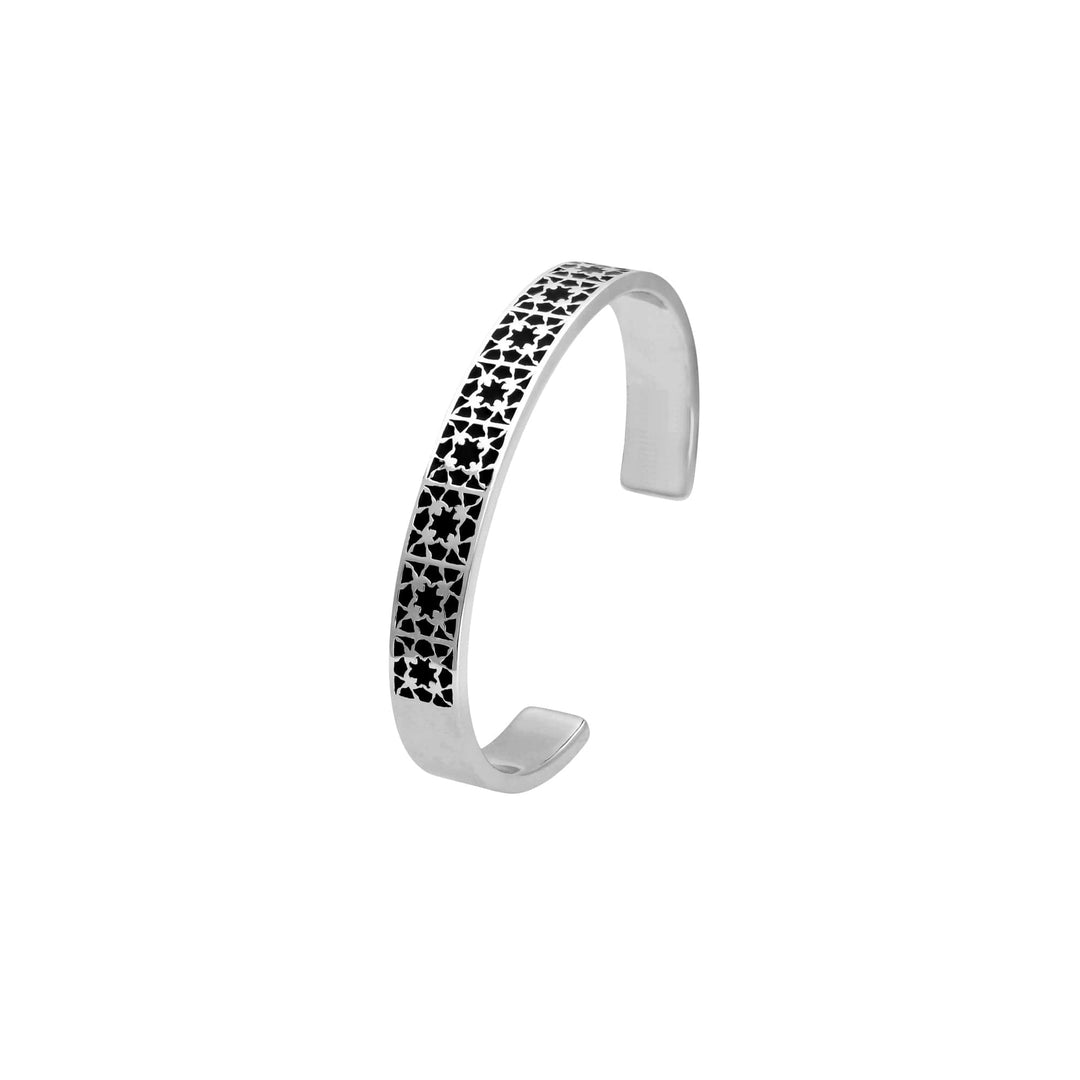 Risis Peranakan Orchid Bangle with Black Enamel - A silver cuff bracelet with a row of black stars, creating a striking contrast and artistic design.
