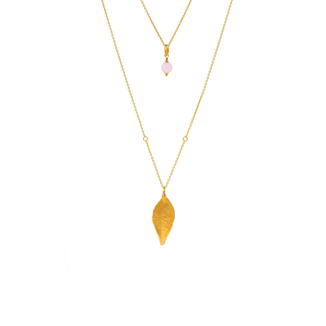 Risis Dawn Necklace With Rose Quartz - A dual-layered gold necklace with a pink bead above a gold leaf pendant, displayed on a transparent background.