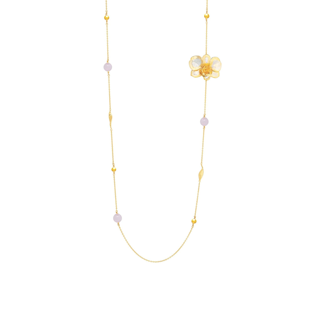 Risis Merry Blossom Necklace - A delicate gold necklace features a translucent flower pendant with pale lavender beads and slim, golden leaves intermittently placed along its chain.