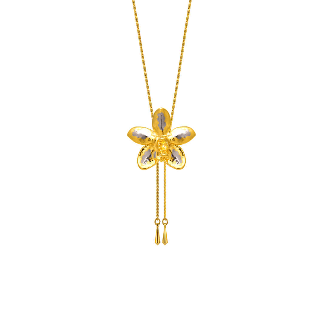 Risis Aeridovanda Vieng Ping Orchid Slider Necklace (PG) - A gold-tone orchid-shaped pendant with reflective petals hangs from a delicate chain, featuring two slender tassels dangling beneath.
