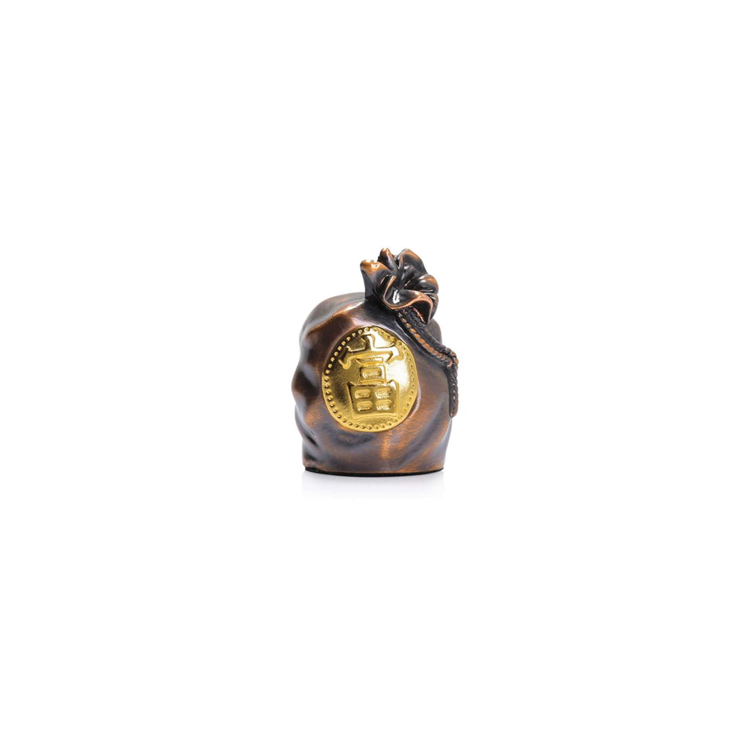 Risis Auspicious Fortune Bag - This is a polished bronze-coloured sculpture resembling a sack, adorned with a pronounced, shiny gold emblem and tied with a dark rope, crafted to symbolize abundance or wealth.