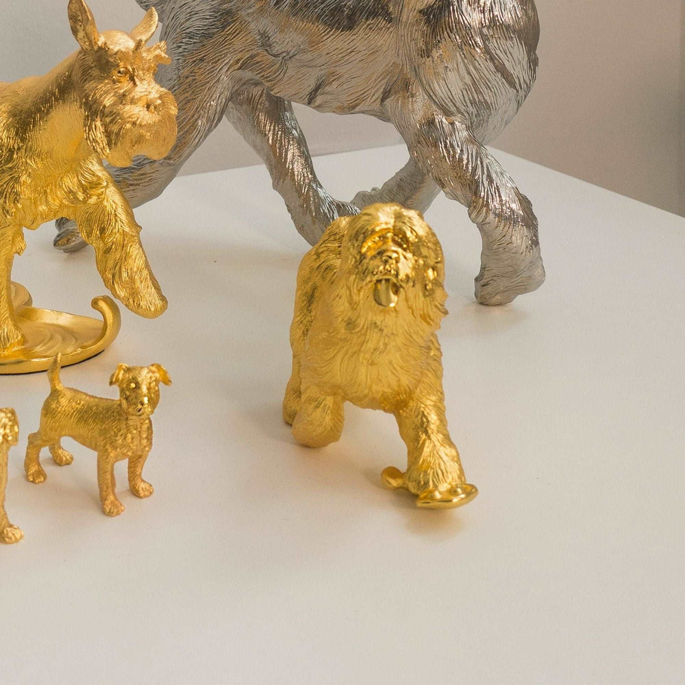Risis Blessings Dog (G) - Golden animal sculptures, predominantly a lion and smaller creatures, display intricate textures and gleam with a metallic sheen, imparting an aesthetic of opulent artistry.