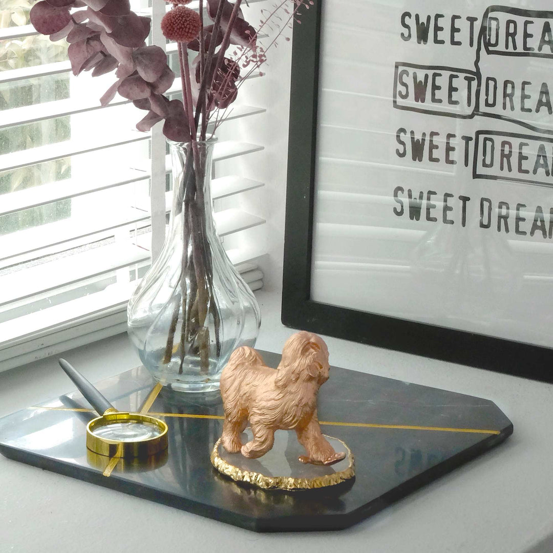 Risis Blessings Dog (G) - A golden figurine of a dog stands atop a sleek black tray, accompanied by a slender golden pen and a small round jar.