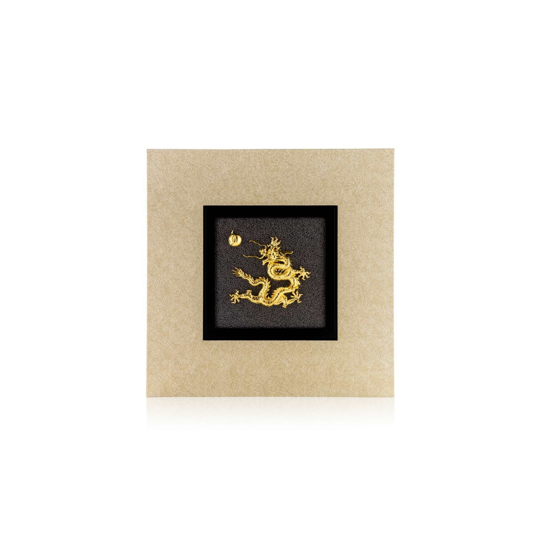 Risis Dragon Celestial Frame - A golden dragon pendant with fine details and textures, presented on a contrasting black square background, creating a bold visual statement within a simple display.