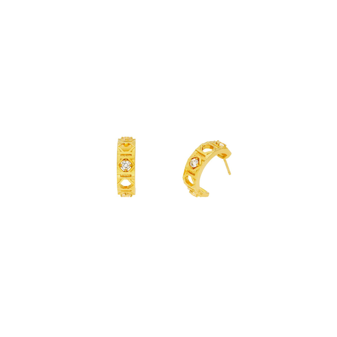 Risis Entwined Rattan Earrings - Three elegant black chopsticks with gold tips are symmetrically arranged on a textured beige backdrop within a dark framed display.