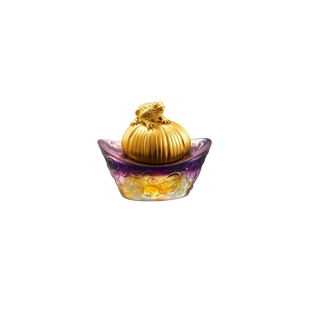 Risis Fortune Toad on Purple Yuan Bao - An ornate, golden-topped container with gradient purple to yellow hues and intricate patterns rests on a plain background.
