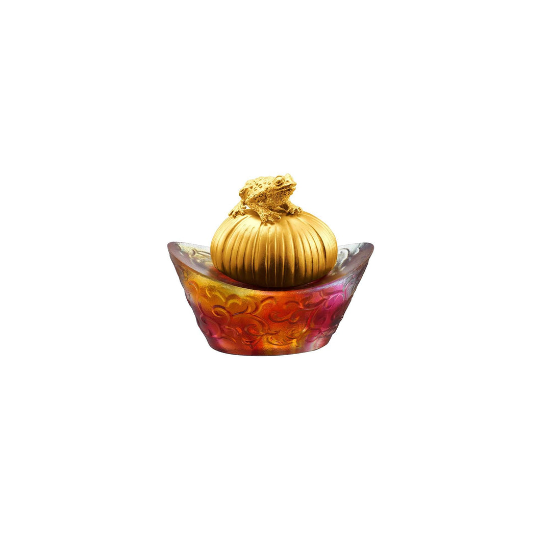 Risis Fortune Toad on Red Yuan Bao - An ornate object featuring a golden pumpkin-like shape with detailed textures set upon a vibrant, floral-patterned bowl in shades of orange, red, and yellow.