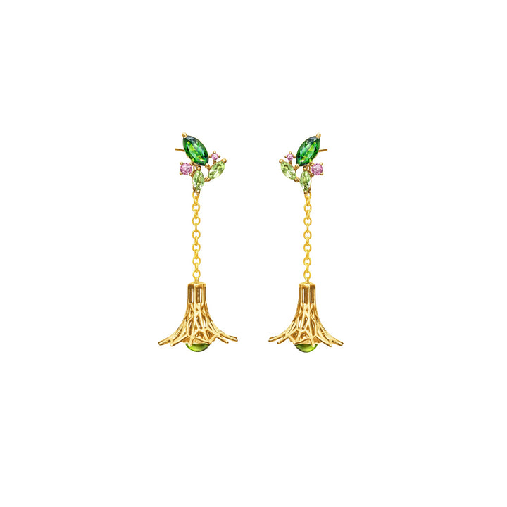 Risis Garden Odyssey Drop Earrings - A pair of golden earrings, each with a marquise-cut green gem flanked by tiny pink gemstones, linked to a chain and bell-shaped pendant with a green accent at the bottom.