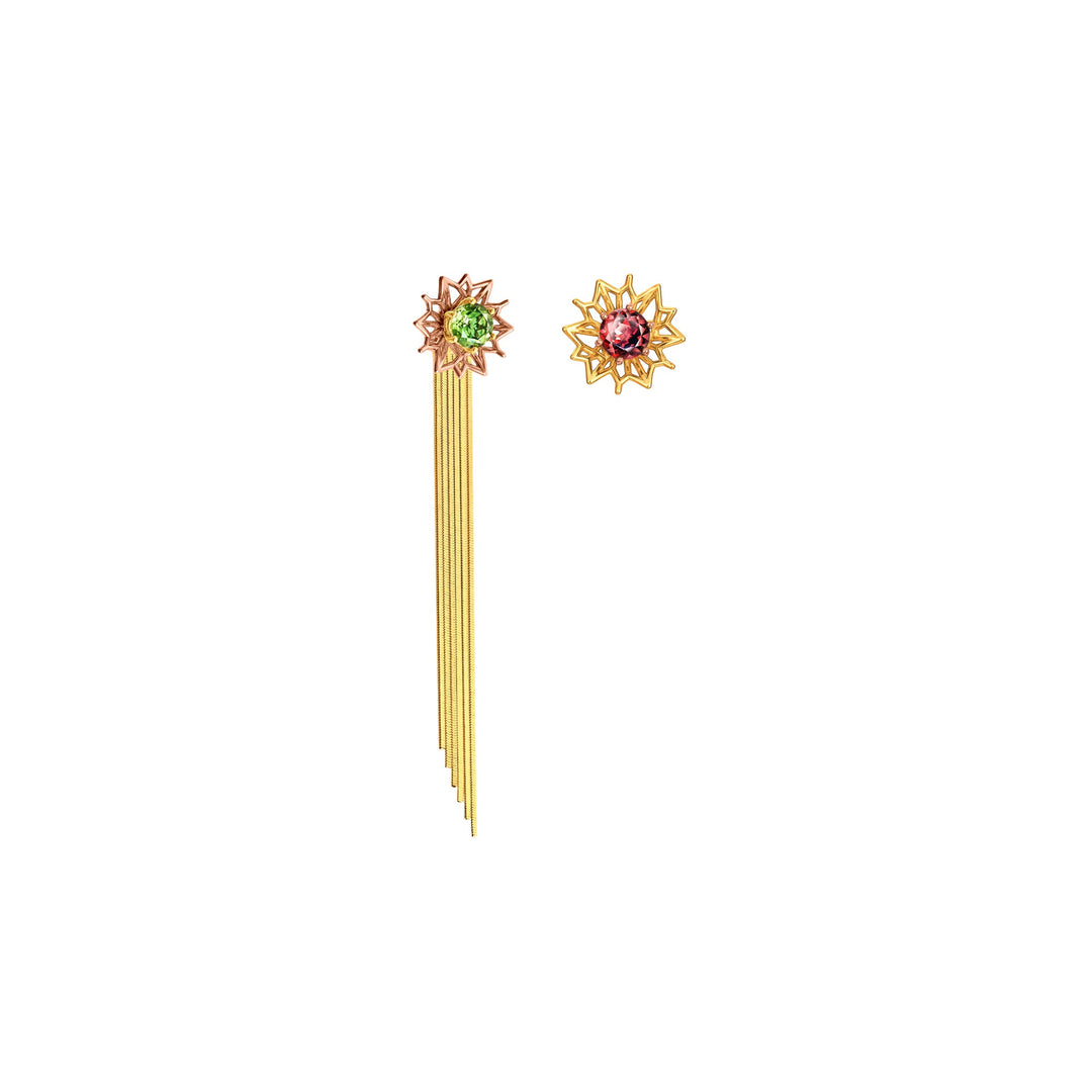 Risis Garden Odyssey Tassel Earrings - A gold-toned hairpin with a starburst design and green gem is paired with a matching gold earring featuring a red gem, both adorned with intricate details.