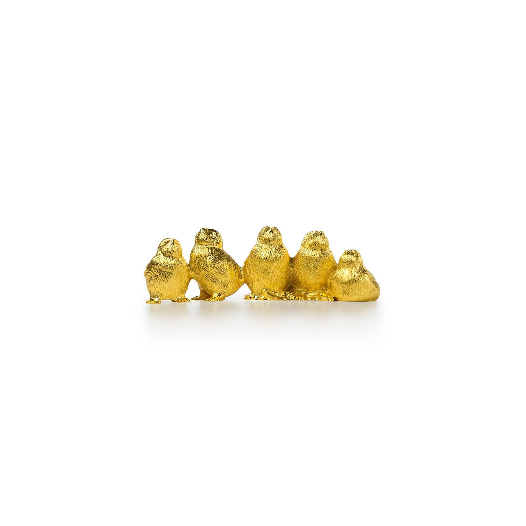 Risis Harmony Chicks - A row of small, golden figurines shaped like chicks, with textured surfaces reflecting light, arranged sequentially on a plain surface.