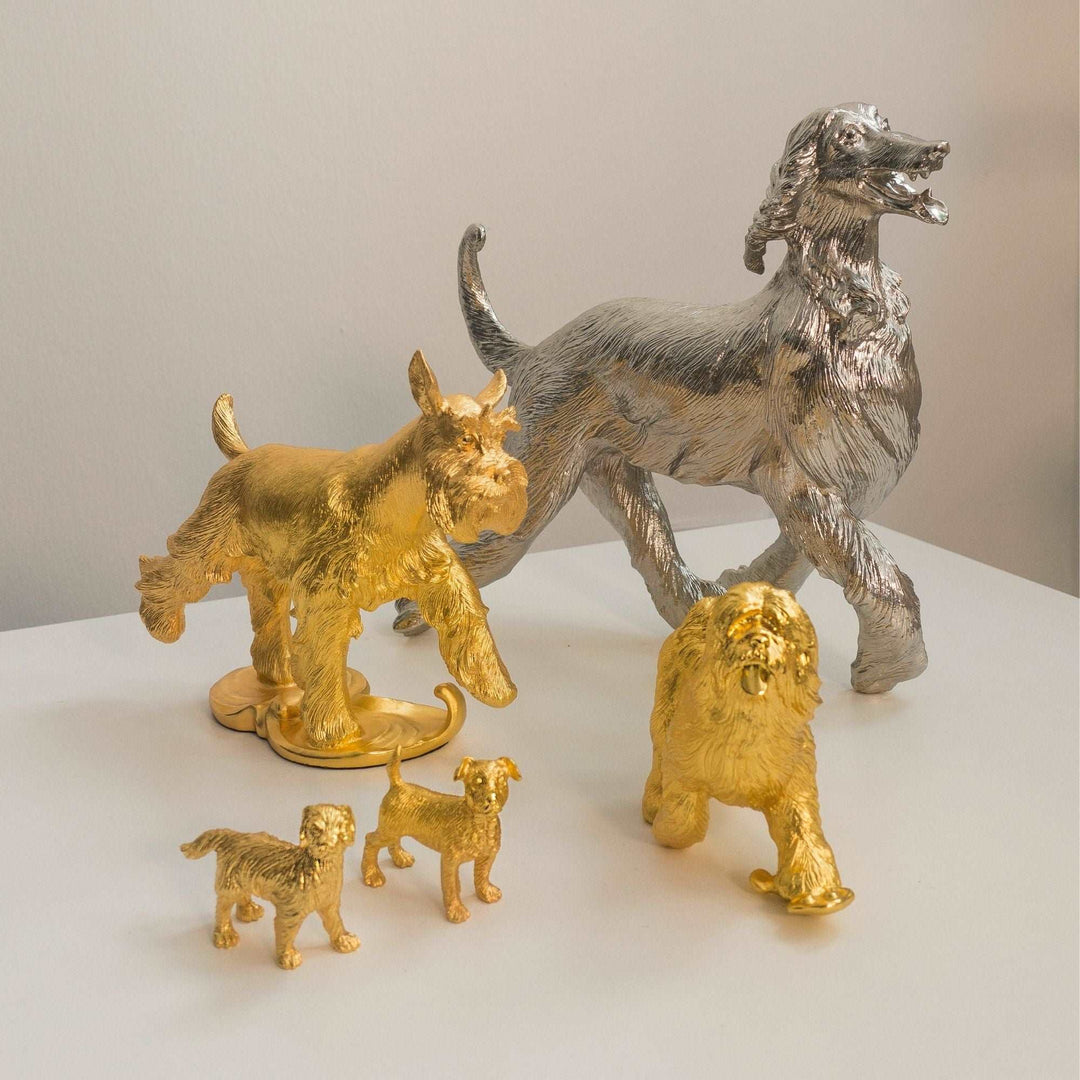 Risis Joy Dog - Metallic canine figurines in gold and silver hues, portraying lively poses and intricate detail, serve as intricate decorative objects.
