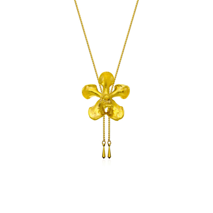 Risis Kagawara Firebird Orchid Slider Necklace (G) - A gold pendant resembling a stylized, four-petaled flower dangles on a thin chain, with two delicate tassels hanging from its bottom.