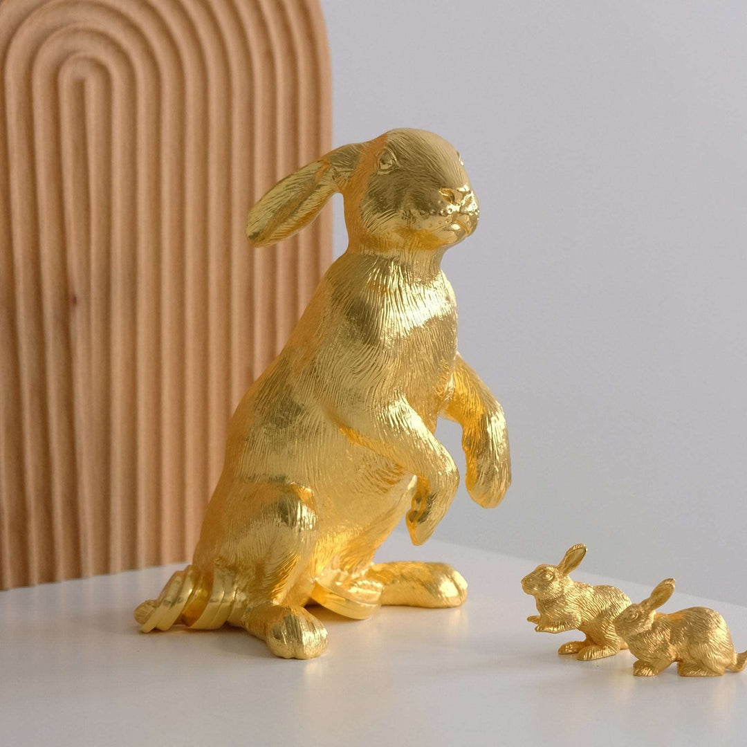 Risis Legend of XII - Rabbit - Golden rabbit figurines, one large and two small, with textured surfaces, give the impression of movement and vitality.