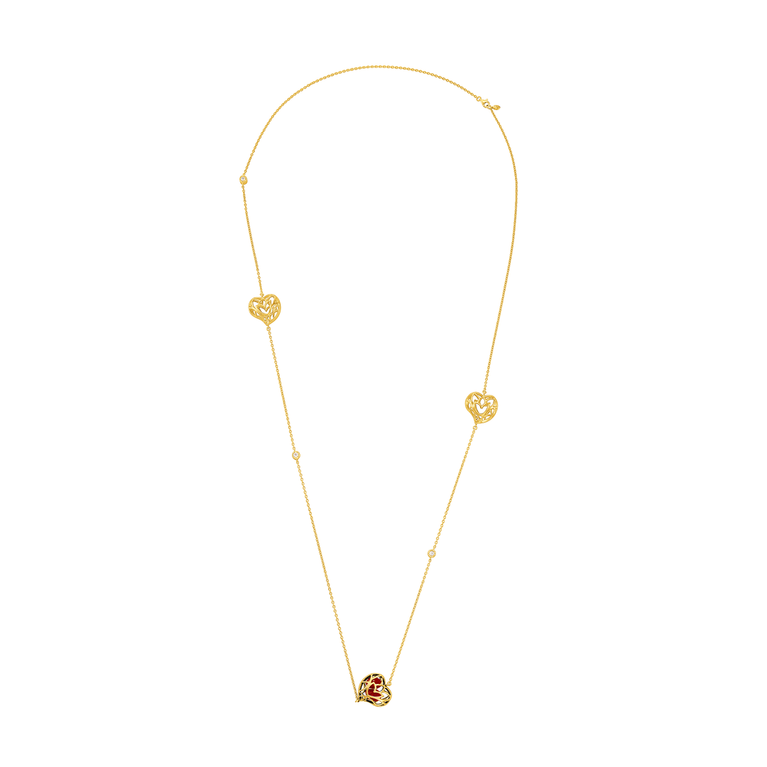 Risis Lotus Heart Saga Seed Long Necklace - A delicate gold necklace with two heart-shaped pendants and a central rose-shaped ornament, all connected by a fine chain.