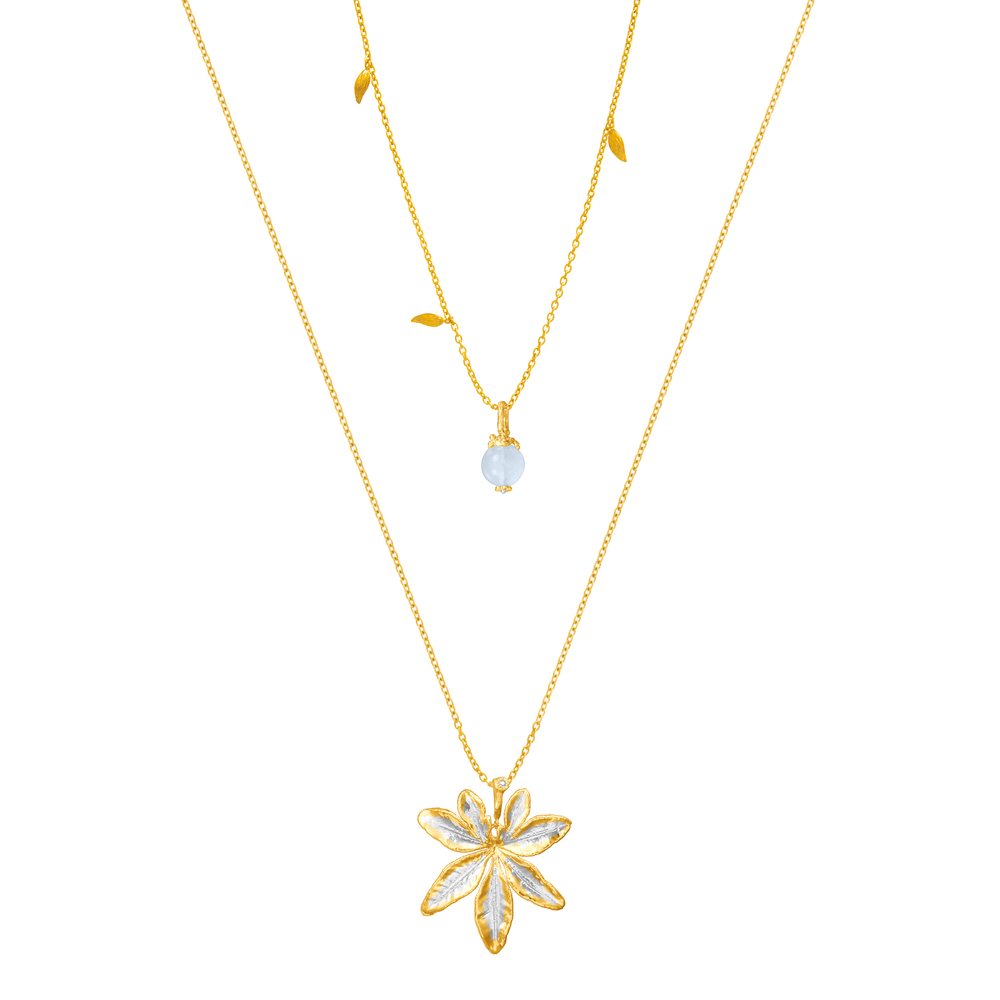 Risis Morning Glory Leaf Necklace with Aquamarine and Topaz - A layered gold necklace set with a translucent bead and a larger gold pendant shaped like an embellished flower with five petals, on a simple chain.