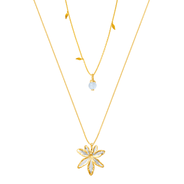 Risis Morning Glory Leaf Necklace with Aquamarine and Topaz - A layered gold necklace set with a translucent bead and a larger gold pendant shaped like an embellished flower with five petals, on a simple chain.