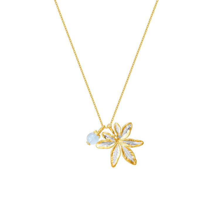 Risis Morning Glory Leaf Necklace with Aquamarine and Topaz - A gold necklace with a pendant shaped like a five-petaled flower, detailed texture, accompanied by a small, pale blue bead.