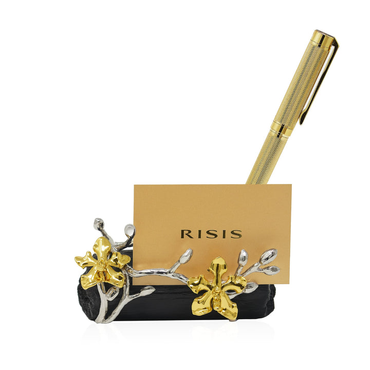 Risis Orchid Spiral Charcoal Pen and Name Card Holder - An ornate metallic card holder features silver branches and golden flowers, holding a golden pen and an amber-colored card with text.