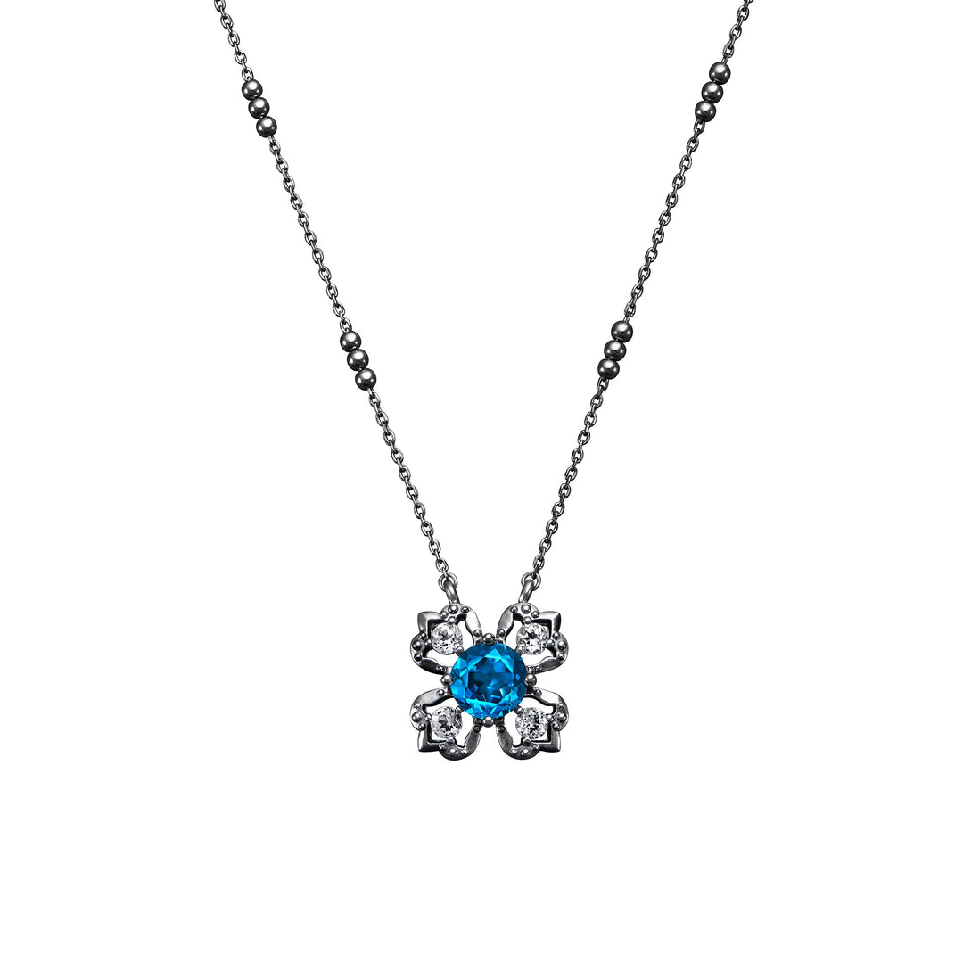Risis Peranakan Kebaya Necklace (BRH) with London Blue Topaz - Black Rhodium - A silver necklace featuring a blue gemstone at the center of an ornate floral pendant with diamond-like accents.
