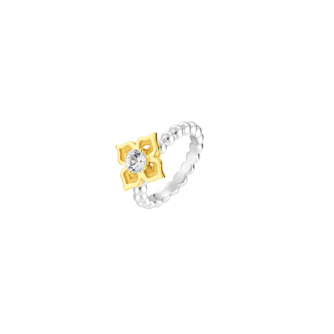 Risis Peranakan Moments Beadwork Ring with White Topaz - A silver-colored beaded ring featuring a gold-toned, four-petaled flower with a shiny central stone. The piece embodies an elegant and modern design.