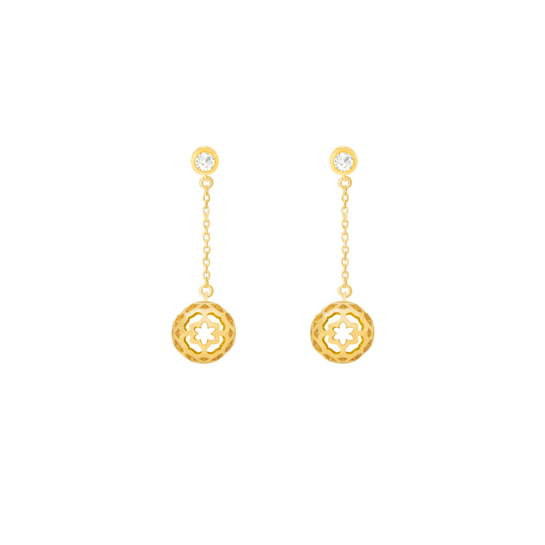 Risis Peranakan Spheres Dangling Earrings with White Topaz (G) - A pair of gold dangle earrings with a circular floral motif and a shiny gemstone at the earlobes.
