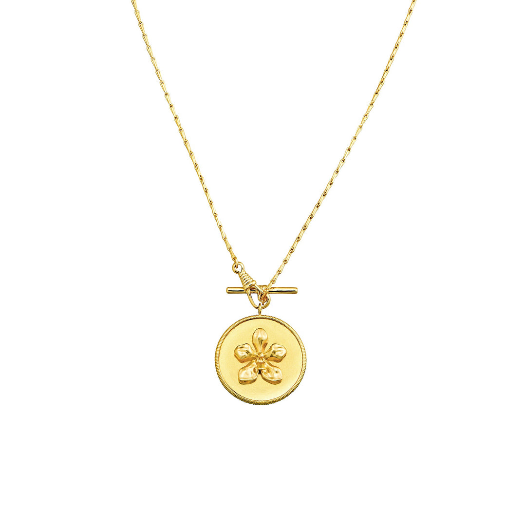 Risis X LINGWU Iconic Vanda Orchid Short Necklace - A golden necklace with a fine chain holds a circular pendant featuring a raised, sculpted four-leaf clover. The pendant has a textured border and a glossy finish.