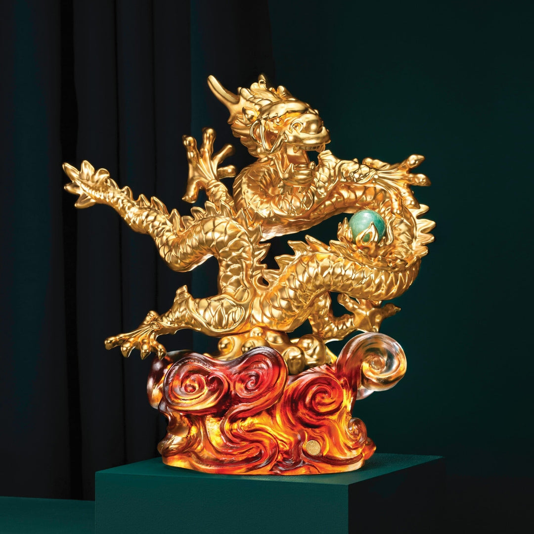 Risis The Imperial Dragon on Amber Liu Li - An ornate golden dragon with intricate scales clutches a pearl, set above swirling red and orange flames, exuding an aura of mythical elegance.