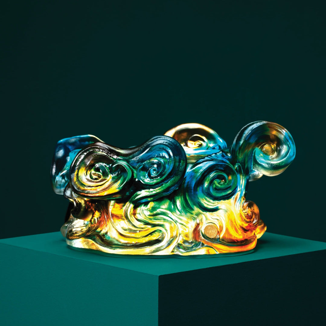 Risis The Imperial Dragon on Blue Liu Li - A vibrant, iridescent sculpture with swirling patterns in blues, greens, and gold, displayed on a pedestal, reminiscent of abstract or impressionist art.