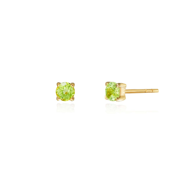Risis Timeless Peranakan Earrings With Peridot - A pair of peridot stud earrings, round cut, prong-set in gold with a clear white background enhancing the gemstones' light green hue and sparkling facets.