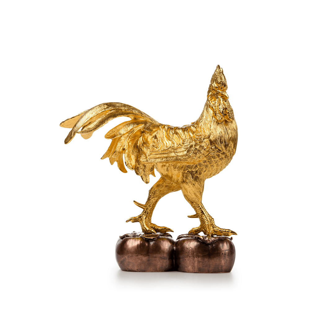 Risis Valour Rooster on Persimmon - A golden rooster sculpture with intricate feather texturing stands atop two bronze-colored objects, displaying elegance and fine craftsmanship.
