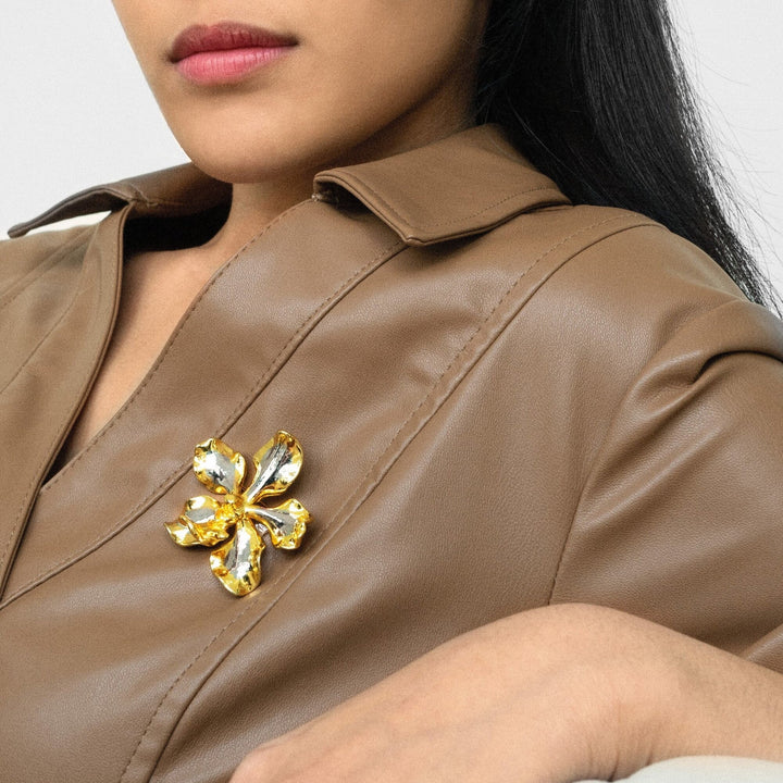 Risis Vanda Hybrid Orchid Brooch/Pendant (L1) (PG) - A person wears a brooch resembling a gold and yellow flower and a delicate necklace featuring a small golden flower pendant.