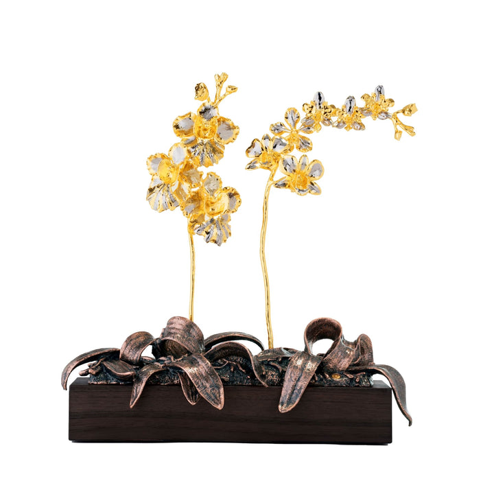 Risis 1974 Garden of Orchids - An ornate sculpture of golden-yellow flowers emerging from bronze-colored leaves arranged on a dark wooden base showcases shimmering petals and intricate details.
