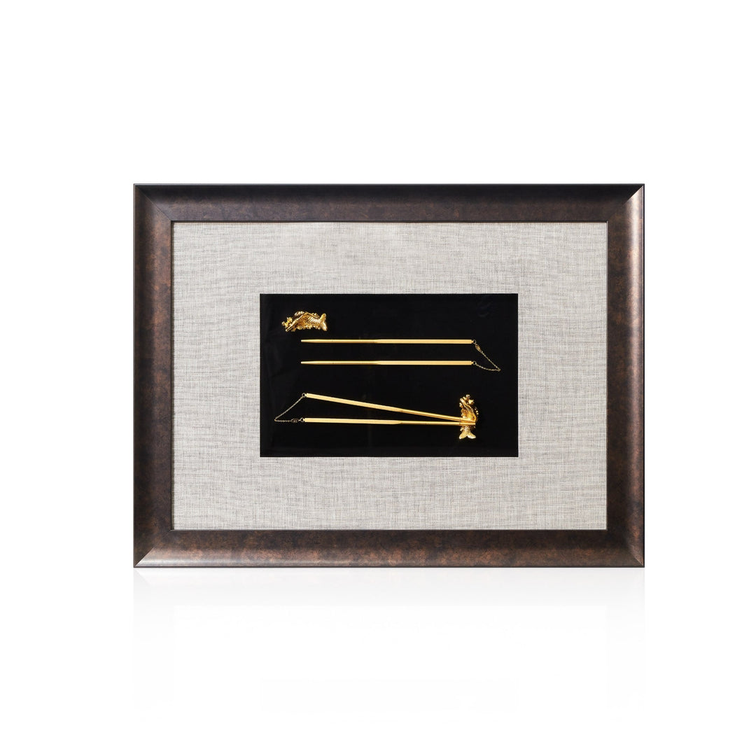 Risis 2 Pairs Chopsticks with Carp Rest Frame II - Two slender golden rods with ornate horse heads and tails displayed horizontally on a black background, mounted in a textured frame.