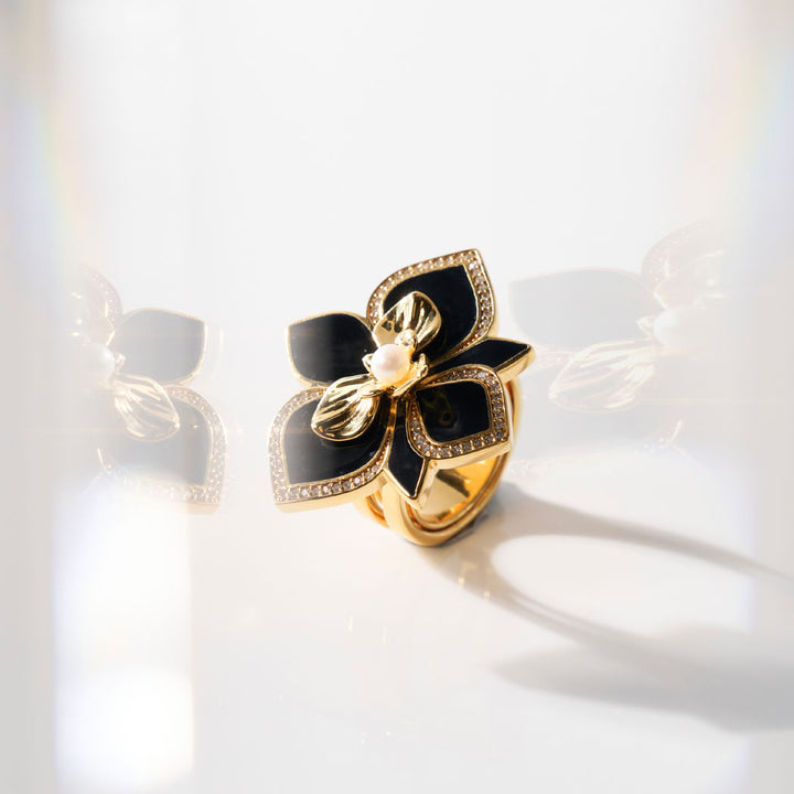 Art Deco Overture orchid ring with black enamel petals, pearl center, pavé-set stones