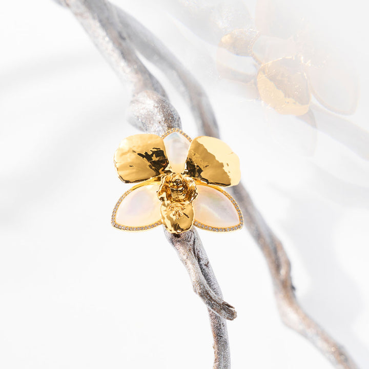Merry Orchid ring with gold orchid flower, mother-of-pearl petals, and pavé diamond edges